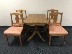 A pine drop leaf table and four chairs
