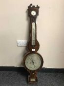 A Victorian inlaid banjo barometer with silvered dial