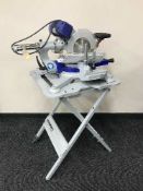 A Elektra Beckum KGS 303 sliding compound saw with accessories on folding table