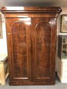 A Victorian mahogany double door wardrobe with fitted interior