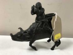 An antique Chinese bronze figure of a man seated on a water buffalo playing a flute