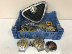 A basket of assorted AA badges, RAC badges,