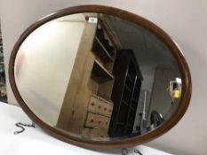 A Victorian inlaid mahogany oval framed mirror