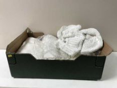 A box containing table linen together with a white lace quilt