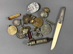 A quantity of un-named First and Second World War medals, badges, silver handled letter knife,