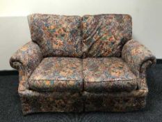 A pair of two seater bed settees in floral fabric