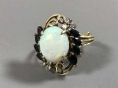 A sapphire and diamond ring set with a large opal
