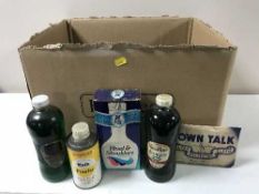 A box containing mid 20th century advertising bottles and tins