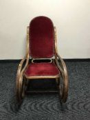 A Bentwood Thonet style rocking chair upholstered in red dralon