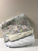 Three floral quilts together with a bed cover