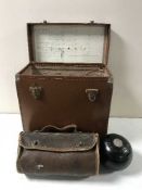 A leather record box containing six vintage wooden lawn bowls