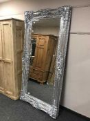 A large silvered bevelled mirror