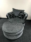 A contemporary revolving cuddle chair with footstool