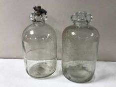 A box containing seven demijohns together with two contemporary vases