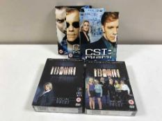 Four boxes of assorted DVDs