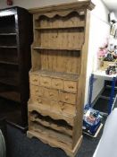 A pine kitchen wine rack dresser fitted nine drawers