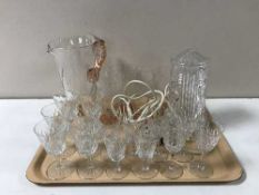 A tray of assorted glassware including a vintage glass table lamp, glass water jug,