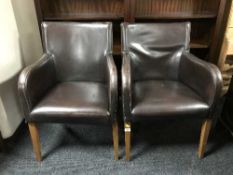A pair of leather armchairs