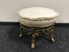A circular gilt dressing table stool