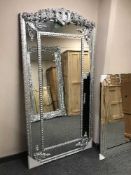 A large contemporary silvered floor standing mirror,