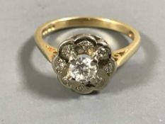 An 18ct gold diamond cluster ring, the central stone estimated at 0.