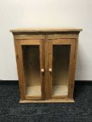 A pine double door glazed cabinet