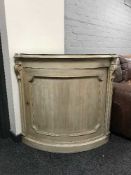 A bleached walnut corner cabinet