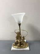 A gilt cherub table lamp