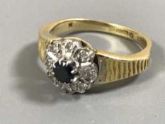 An 18ct gold sapphire and diamond cluster ring, 4.