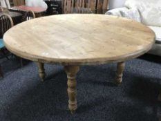 A circular pine farmhouse kitchen table