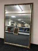 A large floral framed mirror,