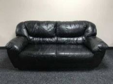 A black leather three seater and two seater settees