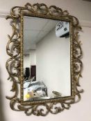 A decorative gilt framed wall mirror