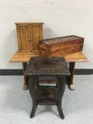 A two-tier poker work plant stand together with a mahogany coffee table,