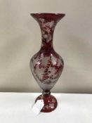 An antique ruby tinted Bohemian glass vase with wheel etched decoration depicting stags in a forest
