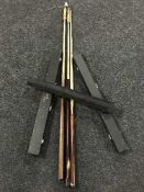 A box containing a large quantity of assorted snooker cues in cases, some with tip protectors,