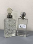 A silver topped cut glass scent bottle and another scent bottle