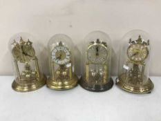 Four anniversary clocks under shades