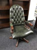 A green button leather Chesterfield swivel armchair