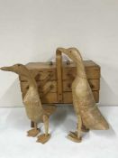 A concertina sewing box and two wooden duck ornaments