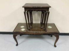 A mahogany glass top coffee table and a nest of three tables