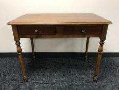 A contemporary two drawer side table in walnut finish