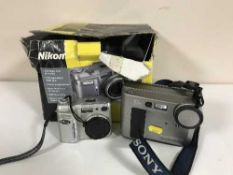 A boxed Nikon Coolpix 880 camera and a Sony digital Mavika camera