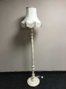 A cream column standard lamp and shade