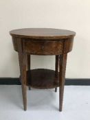 An inlaid mahogany oval side table fitted a drawer