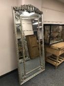 A large tall silvered mirror