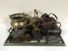 A tray of brass hanging planter and kettle, hearth brush, scoop, flat irons,