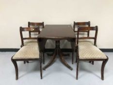 A mahogany drop leaf pedestal table and four chairs