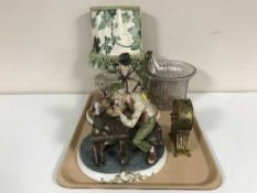 A small gilt French style mantel clock, two Capo di Monte figures, two glass shades,