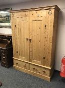 A pine double door wardrobe fitted two drawers